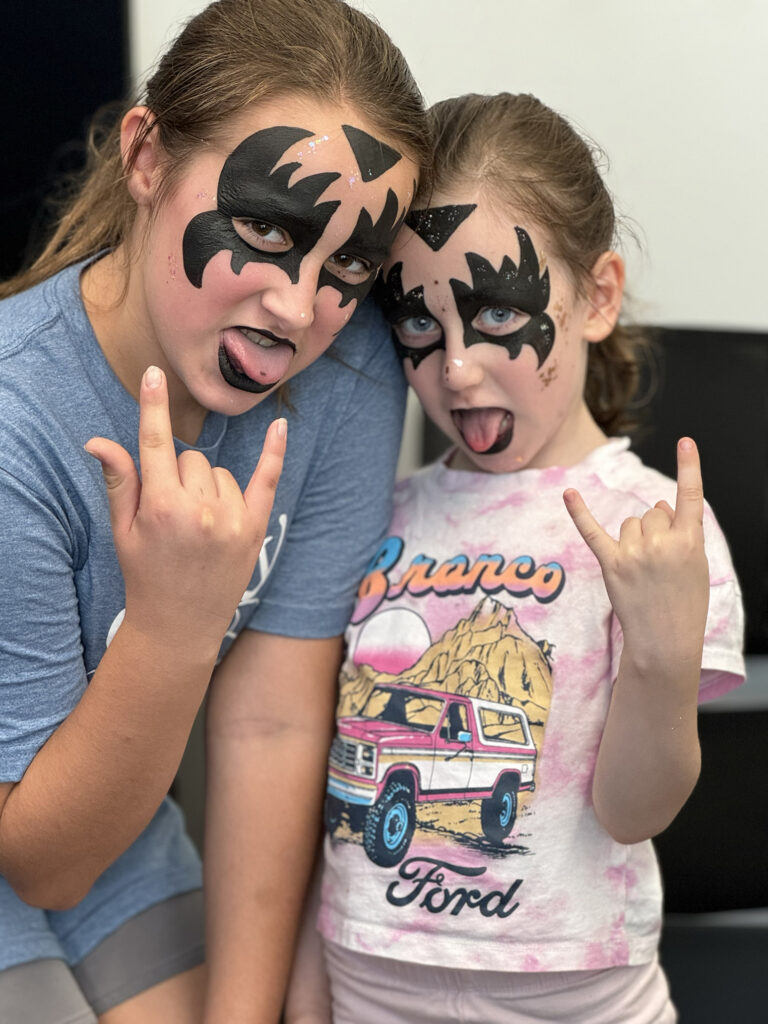 Laughing children with Gene Simmons / Jojo Siwa designs at a sports gathering